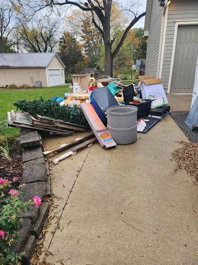 Dumpster being loaded with debris for 10 Yard Dumpster Rental in Sidney